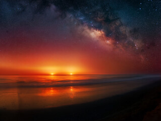Pink and Orange Sunset Over Calm Ocean with Milky Way Galaxy