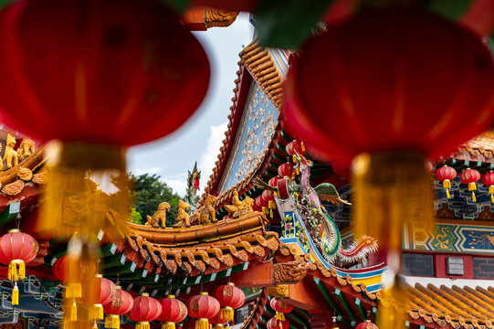 Chinese lanterns framing temple rooftop