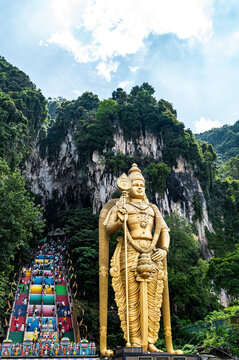 Golden Lord Murugan statue and colorful staircase at Batu Caves