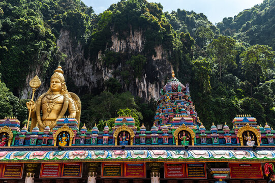 Colorful Hindu temple with limestone cave and jungle view