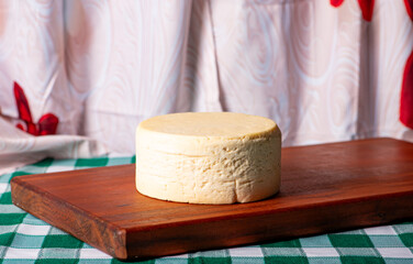 Semi-cured cheese made in Minas Gerais, Brazil, on a rustic surface and