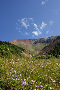 red mountain landscape with blue sky and clouds