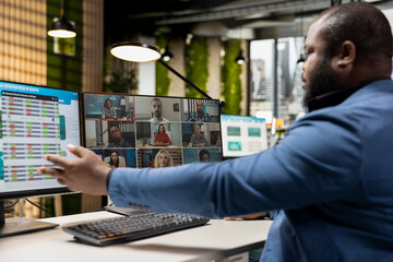 Fototapeta premium Professional team engaging in a business meeting on web video call, discussing with associates about a new partnership to help expand the company globally. Online conferencing chat.