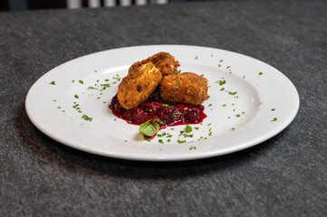 Crispy Fried Camembert Cheese with Sweet Cranberry Sauce on White Plate. Gourmet Appetizer Dish