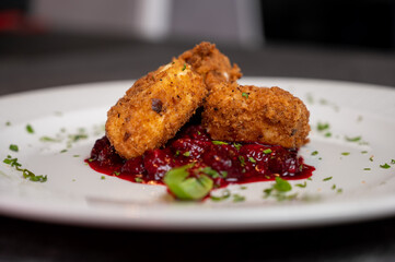 Crispy Fried Camembert Cheese with Sweet Cranberry Sauce on White Plate. Gourmet Appetizer Dish