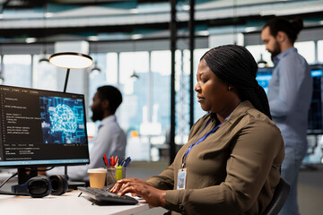 Software engineer using AI automation in tech workspace, building digital solutions. African...