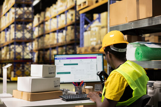 Large business warehouse staff processing orders with awb for online tracking, ensuring import export activity for e-commerce retail industry. Efficient shipping and order fulfillment.