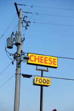 Signs near freeway rest stop offering cheese and food. High tech pole caring electricity and electrical components. Chicago Illinois IL USA