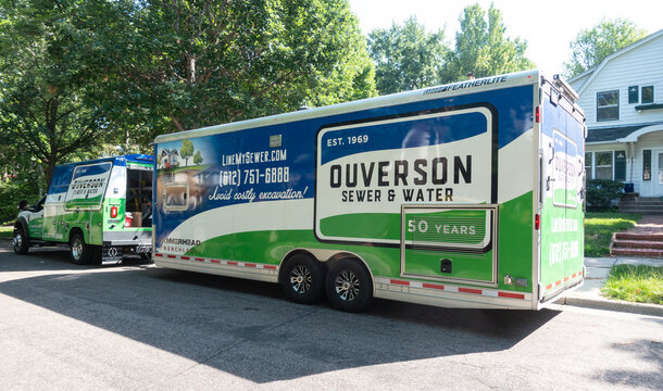 Ouverson Sewer and Water trailer parked in the residential neighborhood to repair sewer lines. St Paul Minnesota MN USA