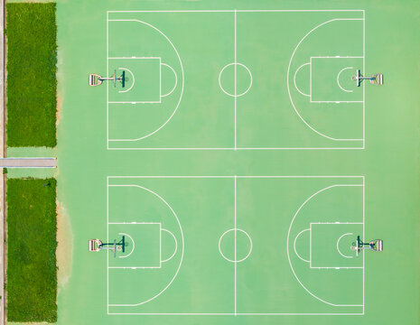 Aerial View of Two Green Basketball Courts with White Lines