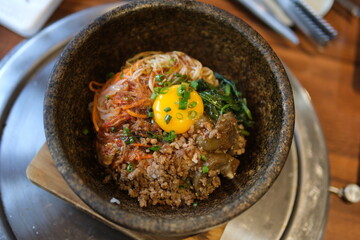 Egg rice beef close-up of a fried egg yolk drizzling over rice, accompanied by steak and sauce.