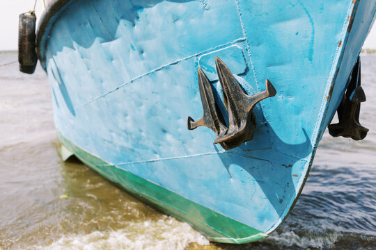 Boat Anchored on Sandy Shore With Gentle Waves Splashing