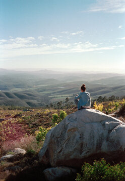 Hiker Enjoying a Scenic View on a Mountain in the Early Afternoon