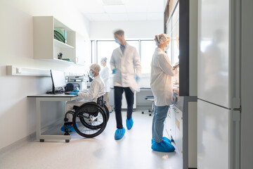 Many Scientists in Modern Bright Laboratory Room