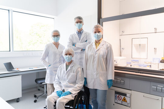 Group Photo Of Scientists in Modern Laboratory