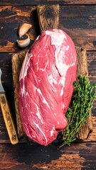Raw beef chuck roast on wooden board