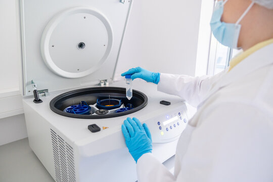 Lab Technician Using Centrifuge for Sample Processing