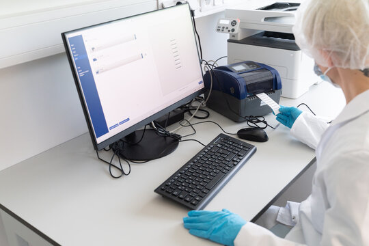 Worker Using Data Printer in Laboratory Setting