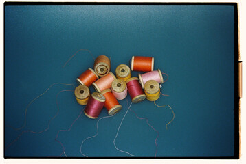 Colorful threads scattered in a warm beam of light