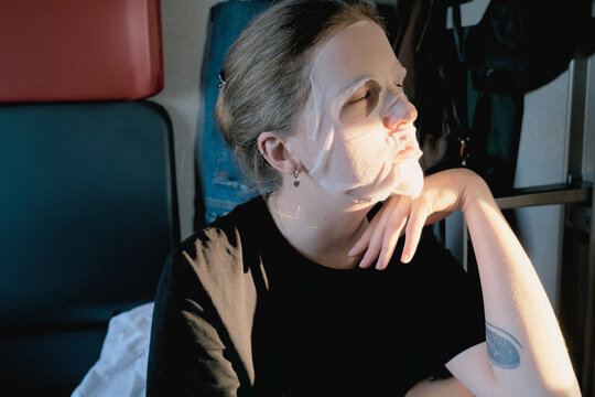 Girl wearung facial mask while sitting in train