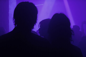 Silhouette of a couple in a underground concert