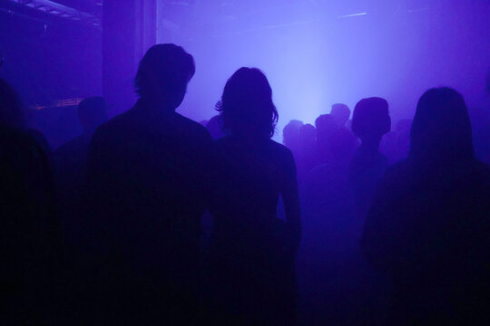 Silhouette of people in a underground concert