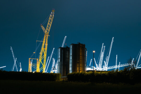 Nuclear power station being built at night.