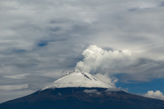 Volcano Emits Steam and Ash Under Cloudy Sky Near the Andes