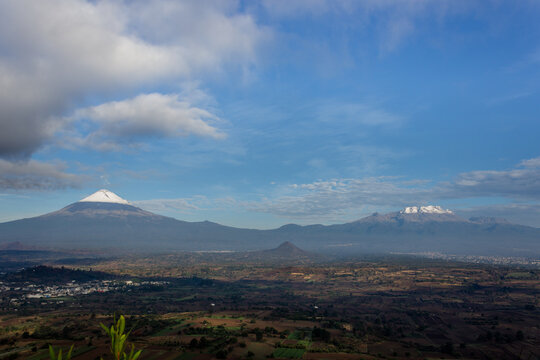 Majestic Volcanoes in Clear Sky Over Rural Landscape 