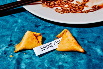 the message shine in an open fortune cookie