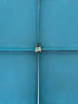 Old lock on blue metal door