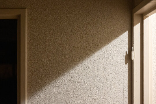 Light Shadows Cast on a Textured Wall in a minimalist house