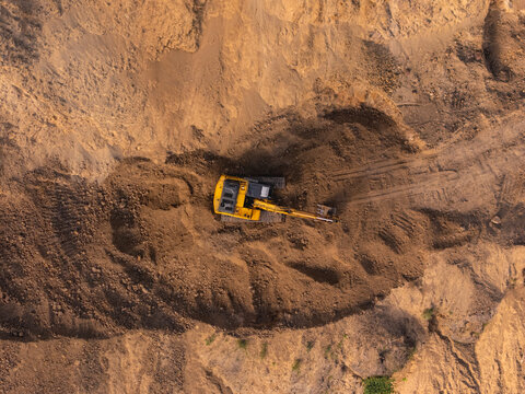 Excavator reshaping the terrain
