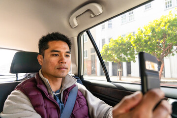 backseat passenger using mobile phone