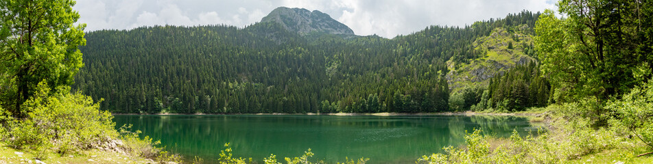 Panorama of mountains rising over Black Lake in Durmitor National Park, in Zabljak, Montenegro