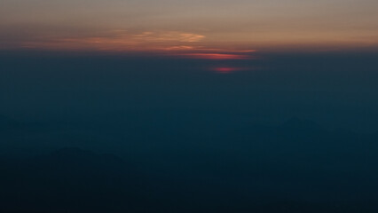 defaultA breathtaking sunrise with vibrant orange hues painting the sky, casting warm light over the landscape and creating a serene, peaceful atmosphere.