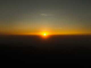 defaultA breathtaking sunrise with vibrant orange hues painting the sky, casting warm light over the landscape and creating a serene, peaceful atmosphere.