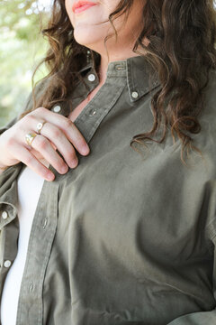 Close-Up of Woman Wearing Olive Green Button-Up Shirt