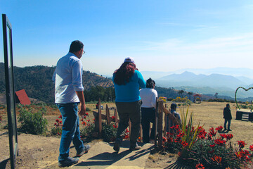Visitors walking through an ecotourism center surrounded by lush nature, enjoying scenic trails and local culture in harmony with the environment.