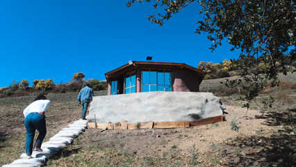 Scenic view of eco-friendly cabins nestled in the forest, blending with nature, offering sustainable lodging surrounded by lush green trees and fresh mountain air