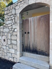 Closed historical medieval wood arch door and stone wall building in Lygaria Heraklion Crete Greece