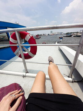POV anonymous female legs on upper deck of a ferry