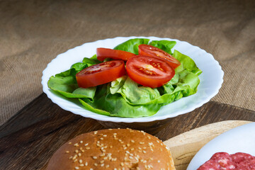 a plate with lettuce and chopped tomato