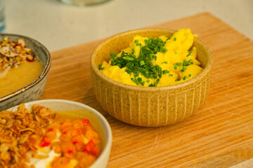 Rustic Wooden Table with scrambled eggs and Fresh Garlic Greens