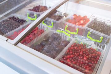 Frozen berries and fruits on a store counter close-up