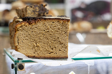 Close-up of freshly baked loaf of rye bread displayed in bakery window