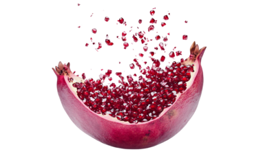 Floating pomegranate splitting open like a tropical flower with vibrant juicy seeds isolated on transparent background PNG