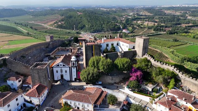 The medieval village of Obidos in Portugal.

Obidos sits on a hill surrounded by fortified walls. It's a famous place and tourist destination in Portugal. 4k.