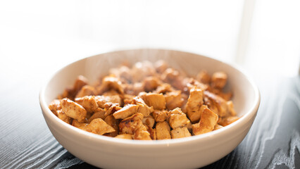 Juicy cubed chicken sautéed with garlic and minimal oil, steaming fresh. Healthy protein dish perfect for meal prep, fitness recipes, and food photography