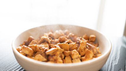 Juicy cubed chicken sautéed with garlic and minimal oil, steaming fresh. Healthy protein dish perfect for meal prep, fitness recipes, and food photography